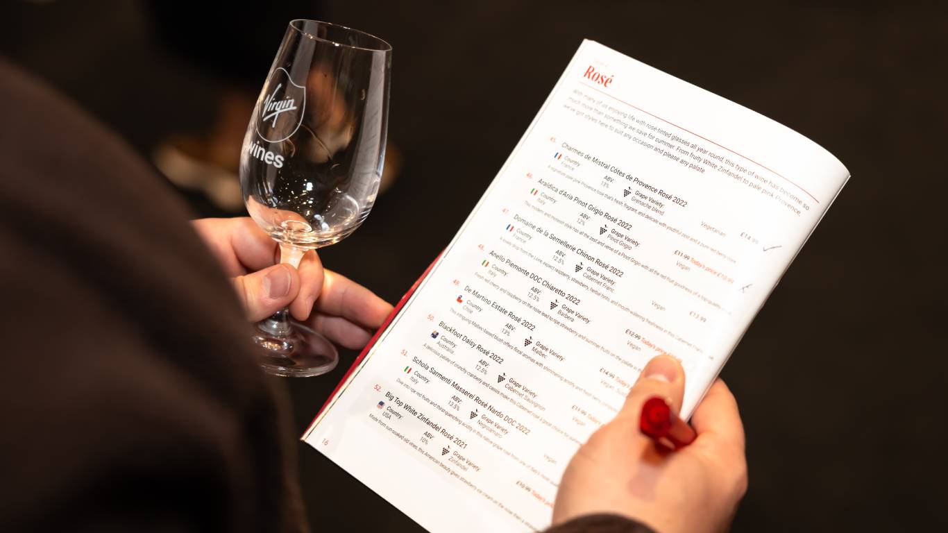 Man looking at a brochure at a Virgin Wines tasting event