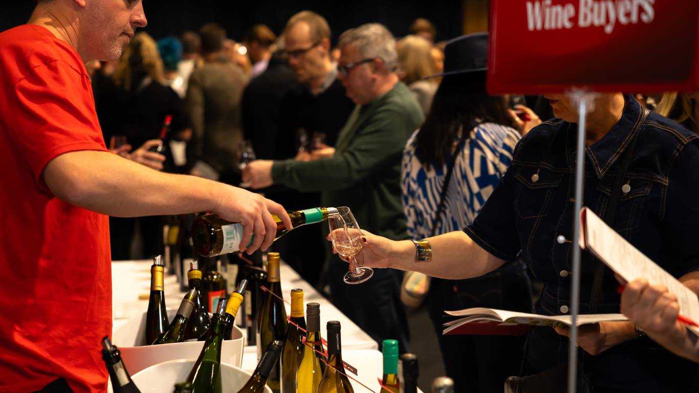 Man serving wine at the Wine Buyer table at a tasting event